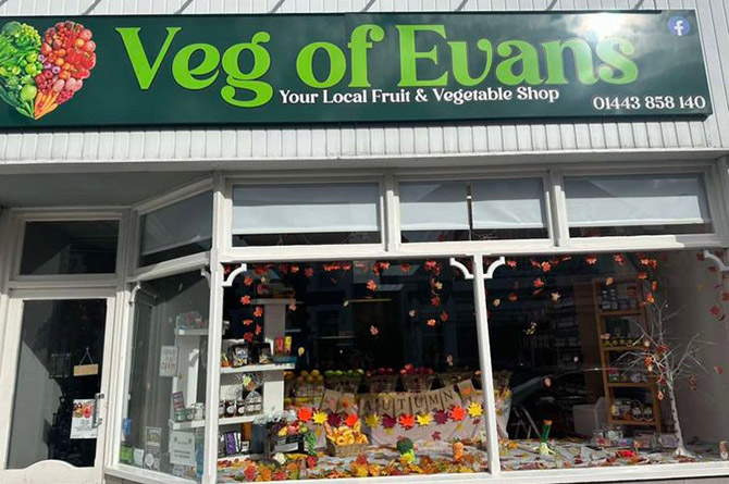 The green Veg of Evans shopfront at 16 Penallta Road, with an autumn display in the window